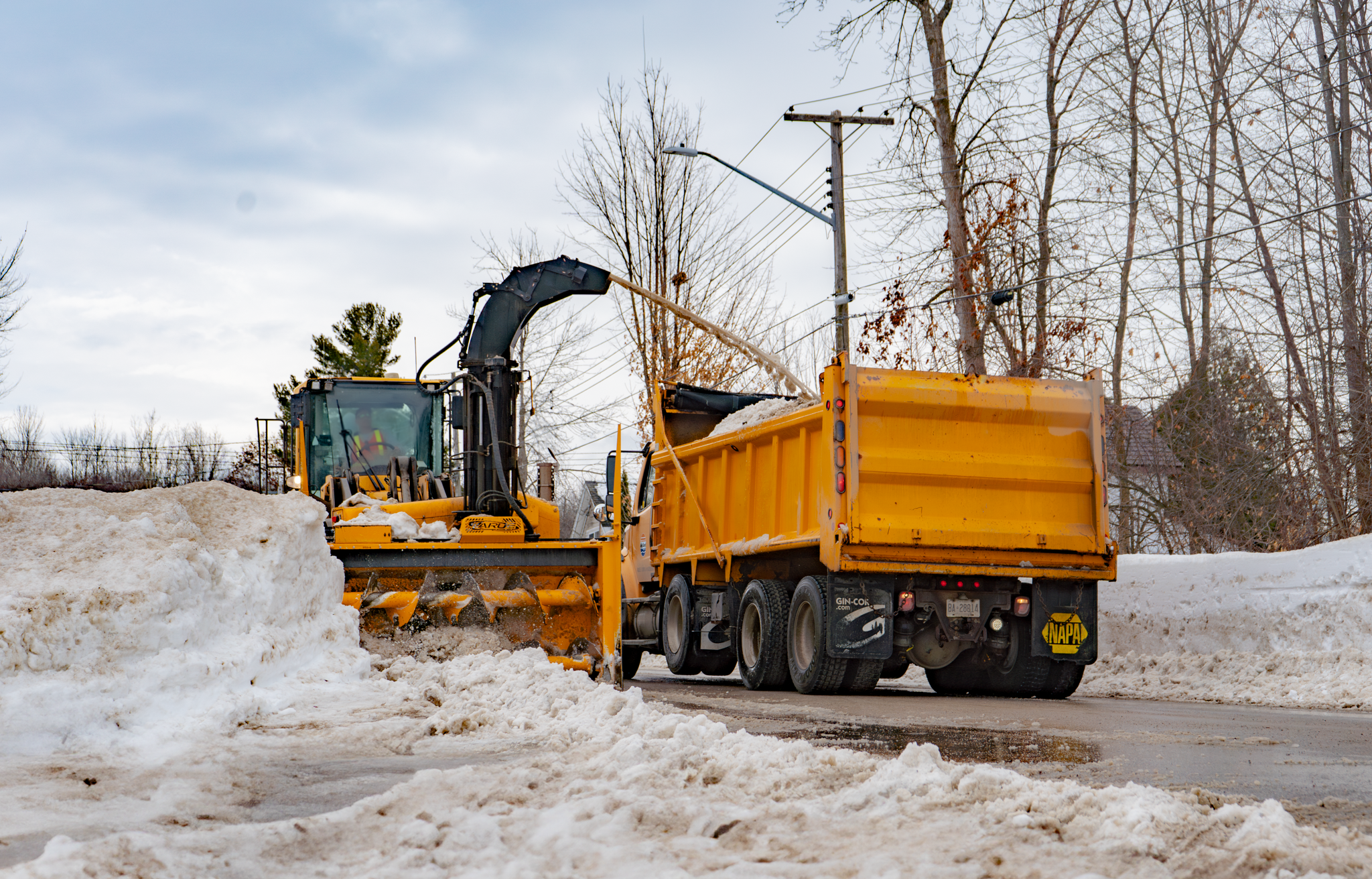 operator removing snow from roadway