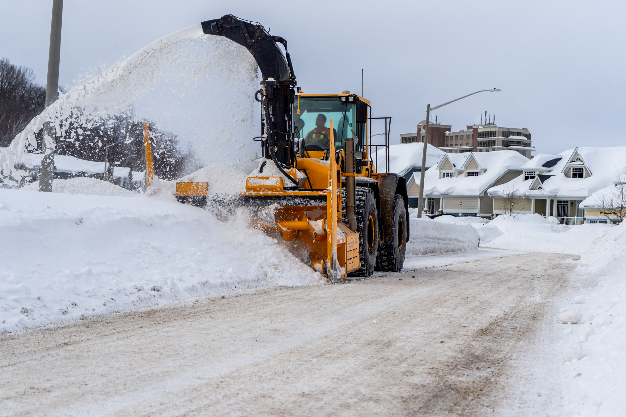 operator removing snow from roadway